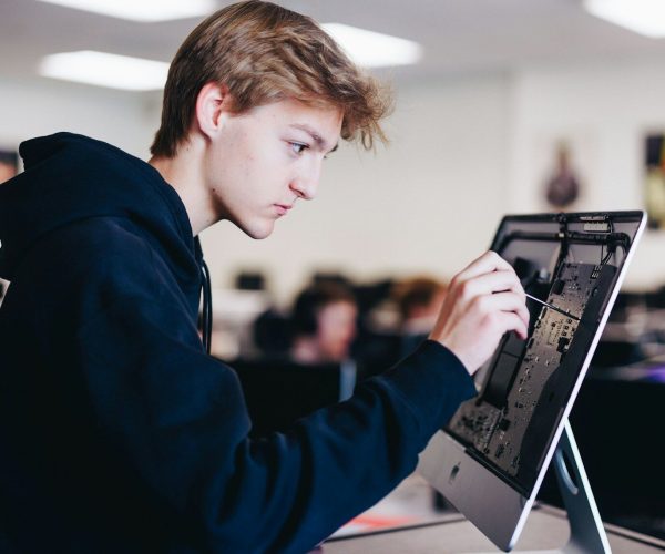 a young man working on a laptop computer